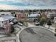 Aerial view of a charming home showcasing a landscaped yard, mature trees, and a cul-de-sac location at 4810 Mountain Gold Run, Broomfield, CO 80023