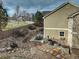 Expansive backyard showcasing a stone patio, lush landscaping, and serene views, perfect for outdoor relaxation at 4810 Mountain Gold Run, Broomfield, CO 80023