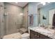 Modern bathroom featuring a glass enclosed shower with a built in bench and marble vanity at 4810 Mountain Gold Run, Broomfield, CO 80023