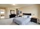 A spacious carpeted bedroom with dark wood furnishings at 4810 Mountain Gold Run, Broomfield, CO 80023