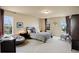 Bedroom featuring a gray bed, neutral walls, and two large windows at 4810 Mountain Gold Run, Broomfield, CO 80023