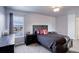 Primary bedroom features dark wood furniture, neutral carpet and decor, and great natural light at 4810 Mountain Gold Run, Broomfield, CO 80023