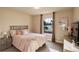 Cozy bedroom with a large window, soft carpet, and plush pink bedding at 4810 Mountain Gold Run, Broomfield, CO 80023