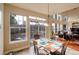 Bright dining area featuring tile floors, multiple windows, and access to outdoor space at 4810 Mountain Gold Run, Broomfield, CO 80023