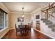 Elegant dining room with hardwood floors, a chandelier, and staircase access at 4810 Mountain Gold Run, Broomfield, CO 80023