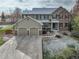 Inviting two-story home featuring a stone and siding exterior with a two car garage at 4810 Mountain Gold Run, Broomfield, CO 80023