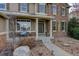 Charming front porch with stone accents, comfortable seating, and a well-maintained walkway at 4810 Mountain Gold Run, Broomfield, CO 80023