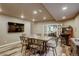 Basement game room is equipped with long table, chairs, TV, and a game machine at 4810 Mountain Gold Run, Broomfield, CO 80023