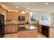 Gourmet kitchen boasts granite counters, stainless appliances, island, and stylish backsplash at 4810 Mountain Gold Run, Broomfield, CO 80023