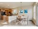 Eat in kitchen features granite countertops, tile flooring, stainless appliances, and adjacent dining area at 4810 Mountain Gold Run, Broomfield, CO 80023