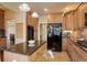 Kitchen boasts stainless fridge and appliances, granite counters, lots of cabinet space, and center island at 4810 Mountain Gold Run, Broomfield, CO 80023