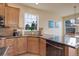 Kitchen with corner sink, light wood cabinets, stainless steel dishwasher and breakfast nook at 4810 Mountain Gold Run, Broomfield, CO 80023