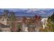 Scenic mountain view from property showcasing snow-capped peaks and verdant trees at 4810 Mountain Gold Run, Broomfield, CO 80023