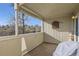 Covered outdoor balcony with a partial view of the community greenery and nearby path at 5075 Garrison St # 3, Wheat Ridge, CO 80033