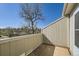 Enclosed outdoor balcony with partial view of the community green space at 5075 Garrison St # 3, Wheat Ridge, CO 80033