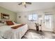 Bright bedroom features stylish decor, ceiling fan, and a door to the outside at 5075 Garrison St # 3, Wheat Ridge, CO 80033