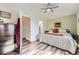 Cozy bedroom with a gray accent wall, wood-look flooring, and access to the ensuite bathroom at 5075 Garrison St # 3, Wheat Ridge, CO 80033