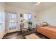 Bright bedroom features a ceiling fan, large windows, and a comfortable workspace at 5075 Garrison St # 3, Wheat Ridge, CO 80033