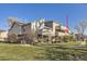 A street view of the apartment complex with balconies and lawn at 5075 Garrison St # 3, Wheat Ridge, CO 80033