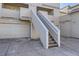 Up close exterior shot showing stair access to upper units with neutral beige siding at 5075 Garrison St # 3, Wheat Ridge, CO 80033