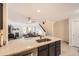 Modern kitchen with black cabinets, stainless steel appliances, granite countertops open to the living room at 5075 Garrison St # 3, Wheat Ridge, CO 80033