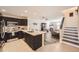 Modern kitchen with black cabinets, stainless steel appliances and granite counters is open to the Gathering room at 5075 Garrison St # 3, Wheat Ridge, CO 80033