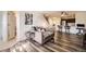 Cozy living room with modern gray sofa, updated flooring, open to the kitchen, and a view of the stairs at 5075 Garrison St # 3, Wheat Ridge, CO 80033