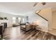 Open floor plan living room with a cozy fireplace, updated flooring, and lots of natural light at 5075 Garrison St # 3, Wheat Ridge, CO 80033