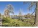 View of community pond surrounded by mature trees and grassy areas, perfect for walking at 5075 Garrison St # 3, Wheat Ridge, CO 80033