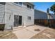 Exterior view of the home's backyard with a concrete patio and fenced yard at 19876 E Brunswick Dr, Aurora, CO 80013