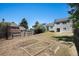 Large backyard features garden beds, a well-maintained lawn, and a private fence at 19876 E Brunswick Dr, Aurora, CO 80013