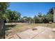 Spacious backyard with a patio area, bordered by a wooden fence, and mature trees at 19876 E Brunswick Dr, Aurora, CO 80013