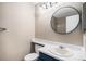 This bathroom features an oval mirror, white countertop, and a blue vanity at 19876 E Brunswick Dr, Aurora, CO 80013