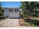 Charming two-story home featuring a two-car garage and well-maintained front yard and steps to the entry at 19876 E Brunswick Dr, Aurora, CO 80013