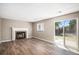 The living room boasts hardwood floors, a cozy fireplace, and a sliding glass door to the backyard at 19876 E Brunswick Dr, Aurora, CO 80013
