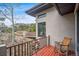 Outdoor balcony offers a relaxing space with a rocking chair and views of surrounding rock outcroppings and scenery at 6767 Timbers Dr, Evergreen, CO 80439