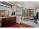 Modern bathroom boasts a glass shower, jetted tub, vanity with a sink, and a view of the forest at 6767 Timbers Dr, Evergreen, CO 80439