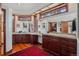 Large bathroom with dual sinks, granite countertops, wood cabinets, large mirrors, and ample storage at 6767 Timbers Dr, Evergreen, CO 80439