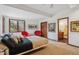 Cozy bedroom with modern furnishings, a large window, and an ensuite bathroom entrance at 6767 Timbers Dr, Evergreen, CO 80439