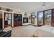 Spacious bedroom with a fireplace, built-in shelves, balcony access, and an ensuite bathroom with glass shower at 6767 Timbers Dr, Evergreen, CO 80439