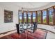 Bright dining room with large curved windows and beautiful views at 6767 Timbers Dr, Evergreen, CO 80439
