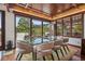 Elegant dining room with wood ceiling, and a beautiful view of the trees and mountains at 6767 Timbers Dr, Evergreen, CO 80439