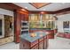 Bright kitchen with a gas range, an island with seating, and wooden ceiling at 6767 Timbers Dr, Evergreen, CO 80439