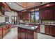 Gourmet kitchen with stainless steel appliances, wooden cabinets and an island at 6767 Timbers Dr, Evergreen, CO 80439