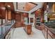 Spacious kitchen with dark cabinets, wooden ceilings, and stainless steel appliances at 6767 Timbers Dr, Evergreen, CO 80439