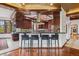 Open kitchen with wood ceiling, counter seating and an island perfect for entertaining at 6767 Timbers Dr, Evergreen, CO 80439