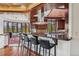 Kitchen with wooden ceiling, island with seating, and views of the mountains at 6767 Timbers Dr, Evergreen, CO 80439