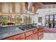 Kitchen with wooden cabinets, wooden ceilings, island with cooktop, and breakfast nook at 6767 Timbers Dr, Evergreen, CO 80439