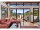 Cozy living room featuring large windows with scenic mountain views and hardwood flooring at 6767 Timbers Dr, Evergreen, CO 80439
