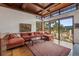 Inviting living room showcasing comfortable seating and breathtaking mountain views at 6767 Timbers Dr, Evergreen, CO 80439